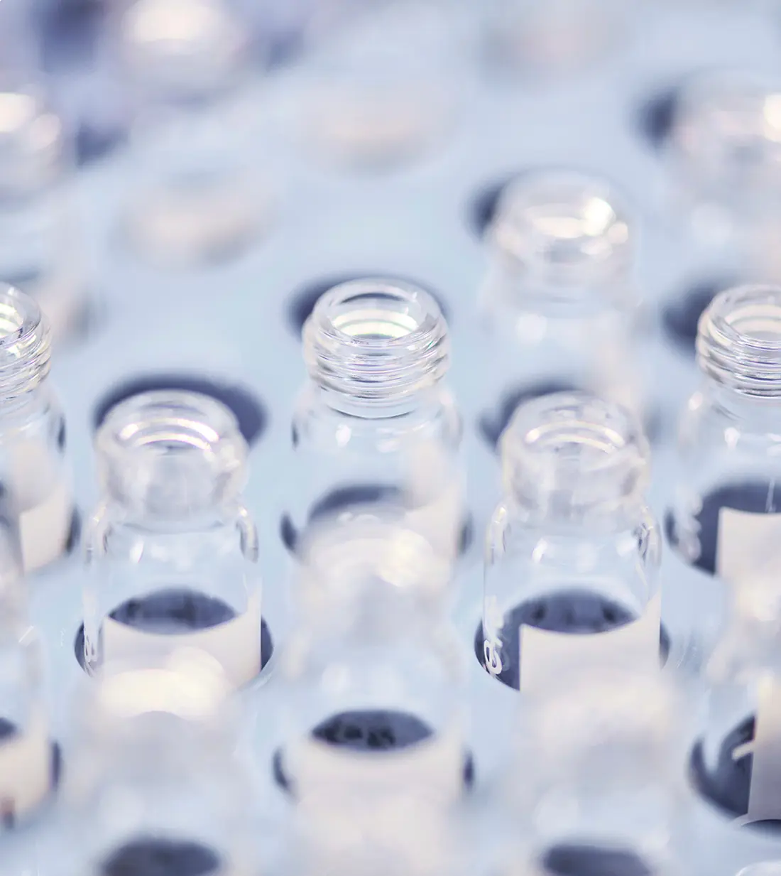 a lot of small glass jars in a tray